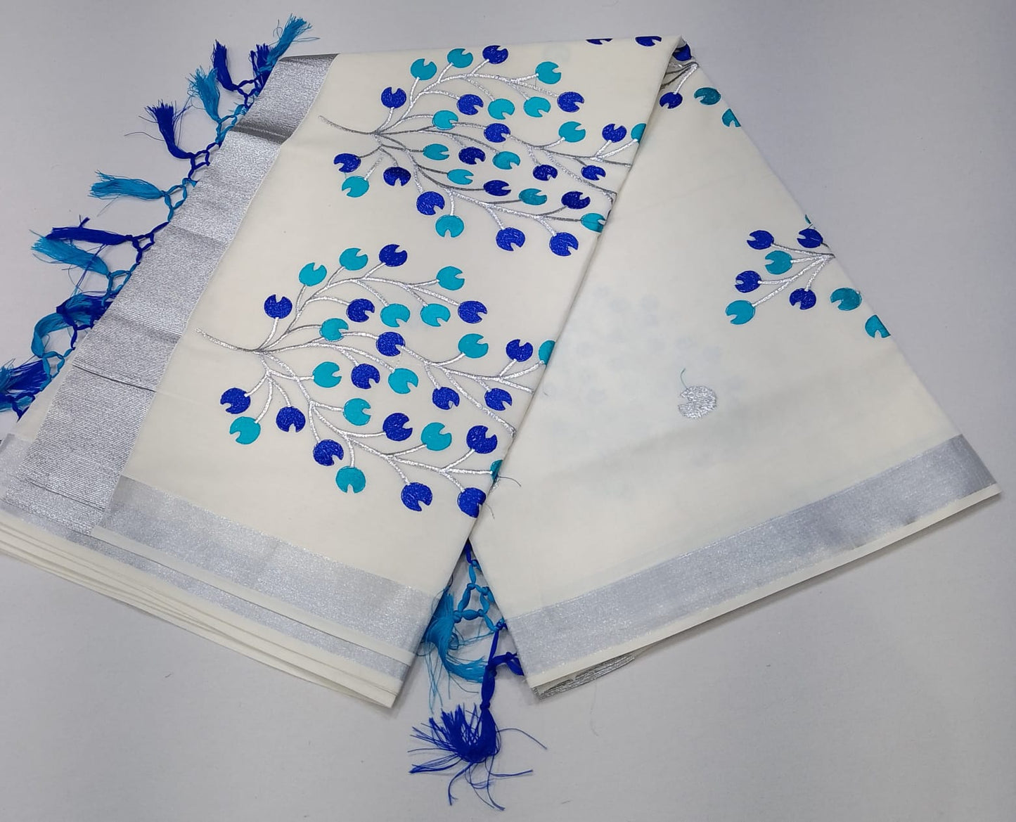 Elegant Off-White Kerala Cotton Saree with Blue Leaf Motif & Silver Kasavu Border