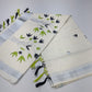 Off-White Kerala Cotton Saree with Black & Parrot Green Floral and Silver Kasavu Border