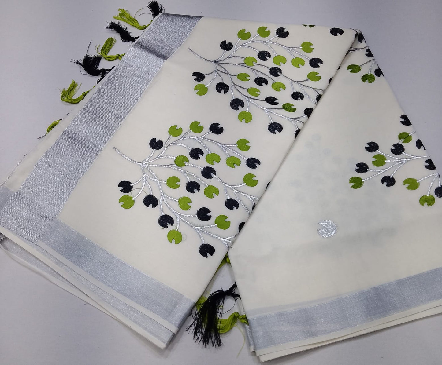 Off-White Kerala Cotton Saree with Black & Parrot Green Leaf Motifs and Silver Kasavu Border