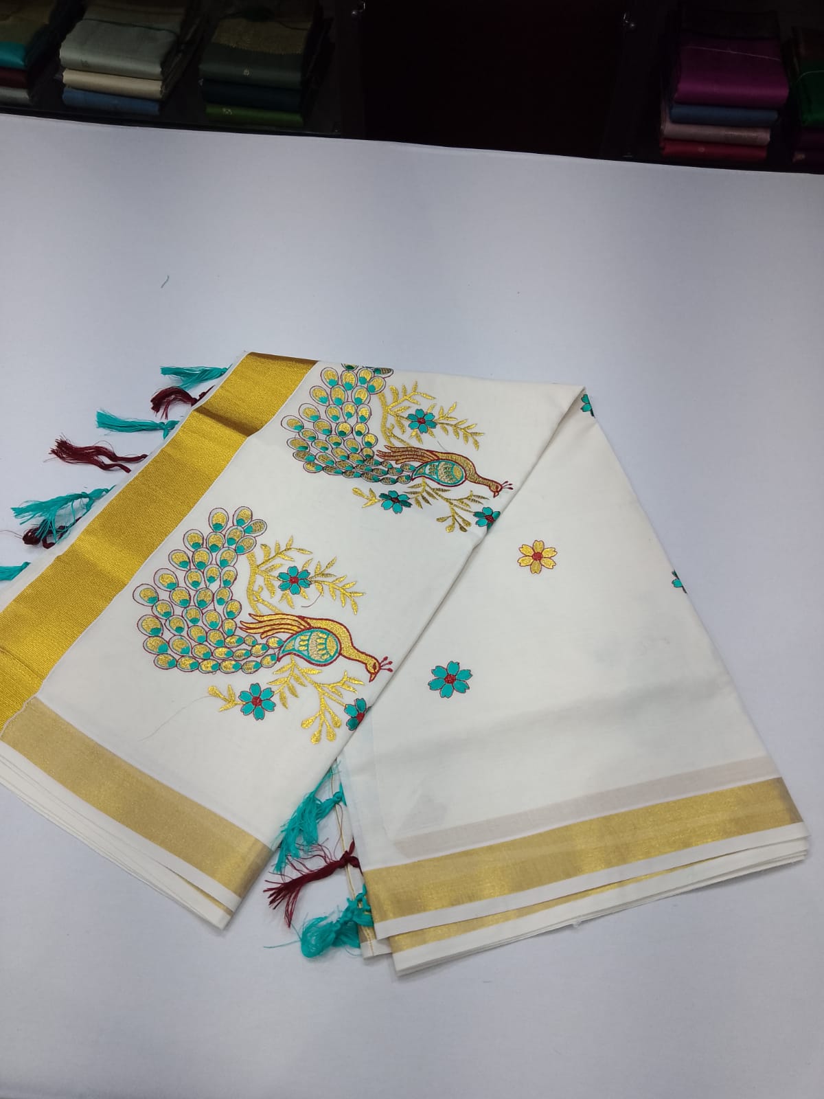 Off-White Kerala Cotton Saree with Peacock Embroidery and Golden Kasavu Border