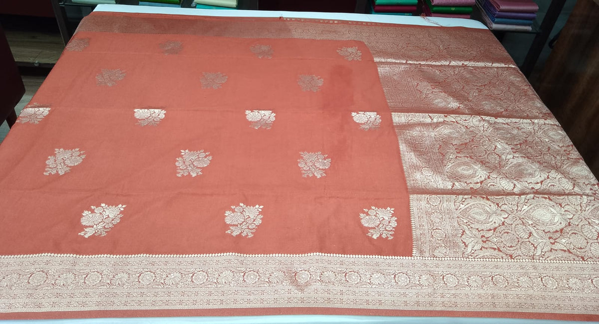 Rust Orange Banarasi Soft Georgette Saree with Silver Zari Floral Buttas and Rich Brocade Pallu