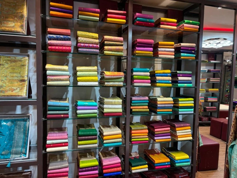 Shelves stacked with pure silk & handloom sarees